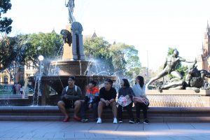 Boys and girls sitting by the fountain