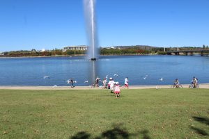 The kids are playing by the fountain