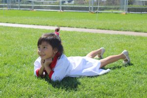 A smily girl laying on the grass